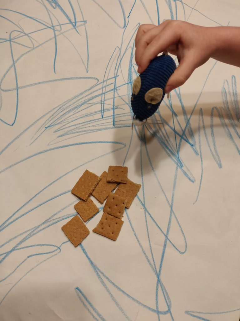 Cat toy mouse being used as a game element for the Magic Rat TTRPG along with graham cracker pieces that we used as trackers.