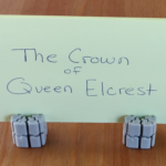 TTRPG item card for a queen's crown - held up on a stand made from Ti'Tains