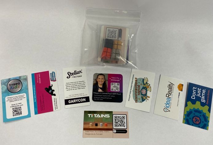 These are the in-person kits being given out at Gary Con.  They include a set of 4 TI'TAINS card holdes and business cards from TI'TAINS, Creators Assemble, Stellar card factory, Dr. Megan Connell, Young Dragon Slayers, IdeaReality, Game to Grow, and TTRPGkids