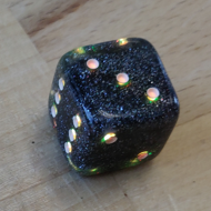 a photo of a d6 showing a 3 and lit up in yellow
