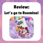 Review: Let’s go to Roomino! shows a photograph of the book on a purple plush blanket