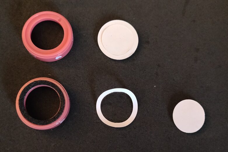 photo of a felt pad being added to one of the ring bases