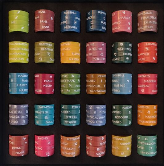 photo of a box full of condition markers for D&D minis