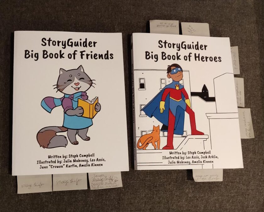 photo of the Big Book of Friends and the Big Book of Heroes with edit tags to indicate pages that need updating