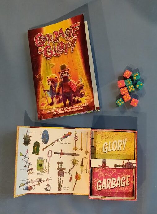 the book, dice, and cards (in their box) for Garbage & Glory