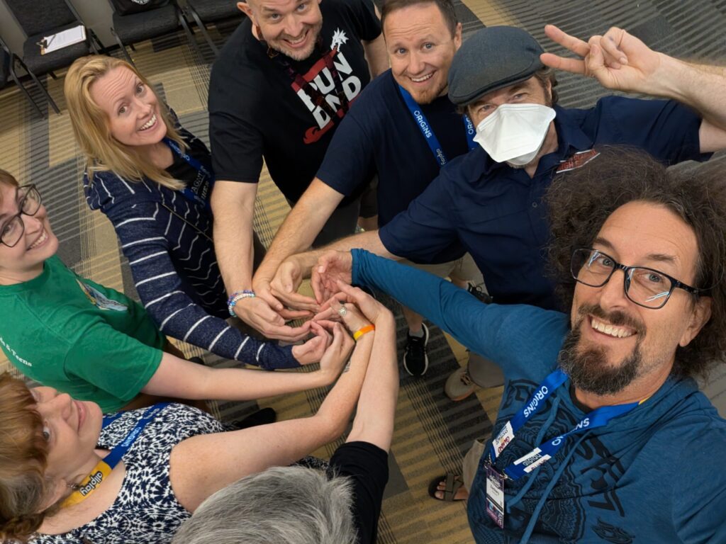 a photo of a whole bunch of people from one of the GBET workshops making a hand spiral!