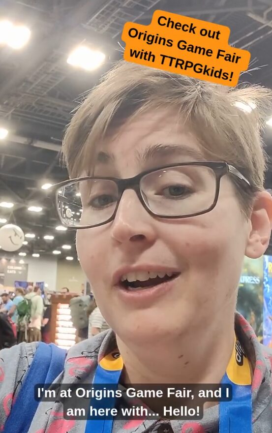 A screencap of one of my videos highlighting the convention!  This image shows me (Steph Campbell) getting ready to introduce creators at their booth.