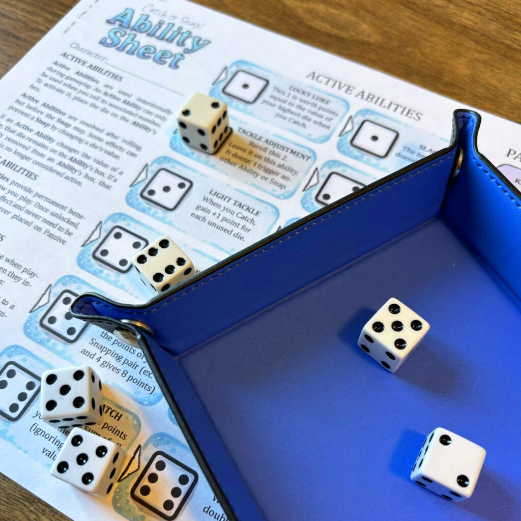 a photo of a dice tray over a printed Catch or Snap dice conditions sheet